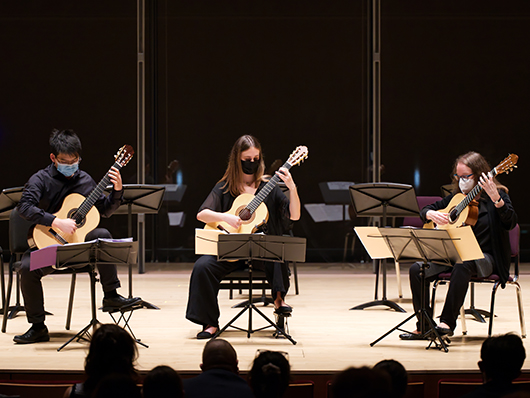 Three guitarists onstage