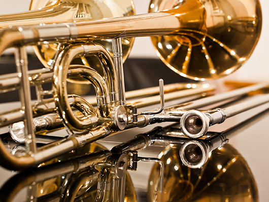 Shining brass instruments on a reflective surface