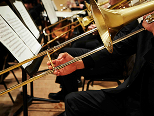 A musician plays trombone onstage.