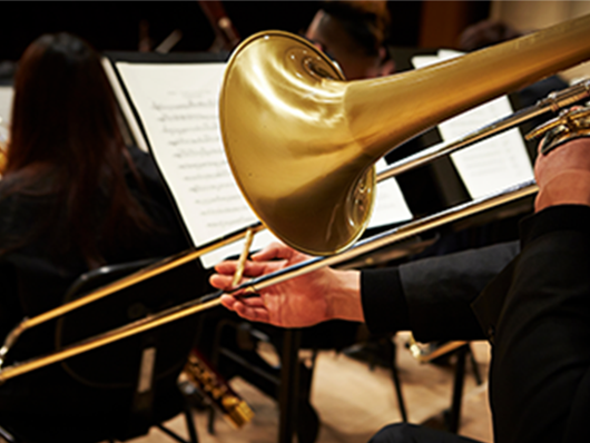 A trombonist plays onstage.