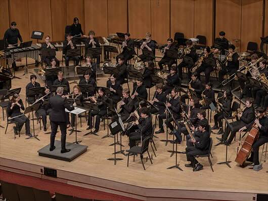 Shawn Vondran conducts the Symphonic Band onstage Pick-Staiger.