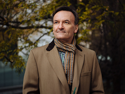 Stephen Hough poses outdoors.