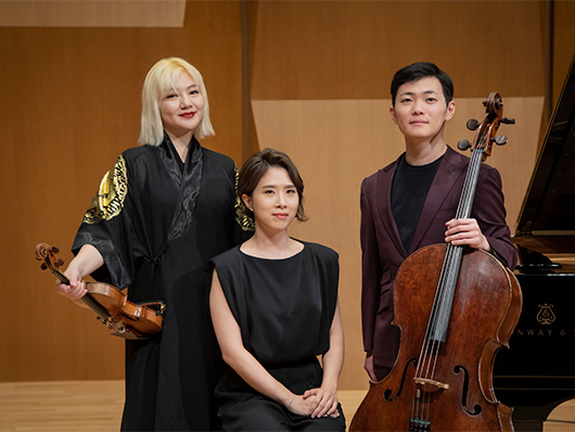 Trio Seoul poses onstage.