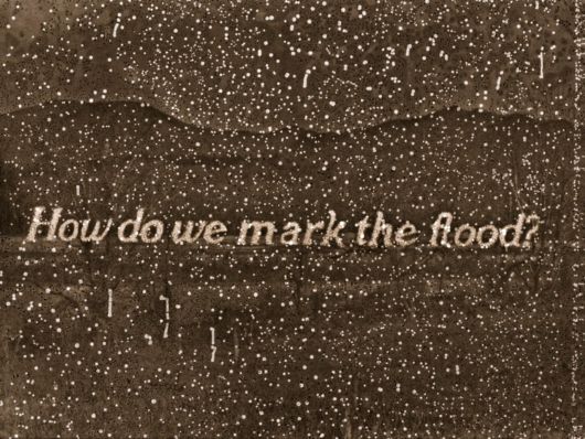 Speckled image of a landscape with text "How do we mark the flood?"