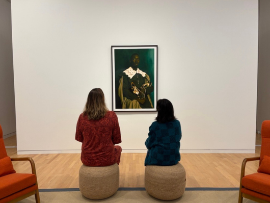 Women looking at art.