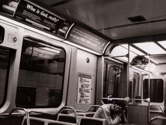 Sad woman in empty train car.