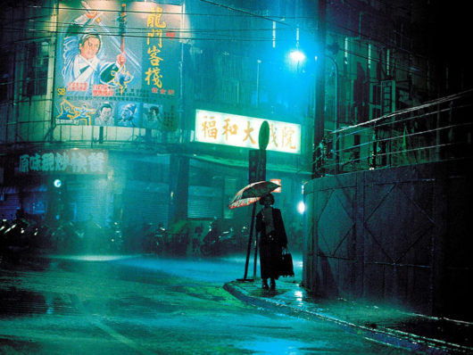 woman walks alone down rainy street