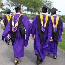 graduating seniors in caps and gowns on the lakefront