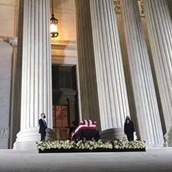 Ginsburg's casket at the top of the Supreme Court steps, flanked by two guards.