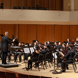Side view of Northwestern's Symphonic Band performing on stage. 