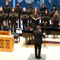 Singers and a keyboardist performing onstage