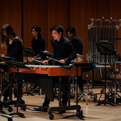 Musicians performing on various percussion instruments