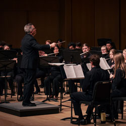Concert Band musicians performing onstage