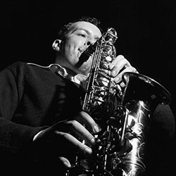 A black and white photo of Jackie McLean playing the saxophone