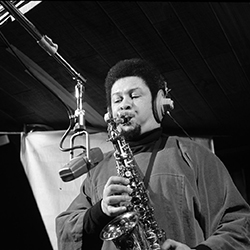 A black and white photo of Frank Foster playing the saxophone