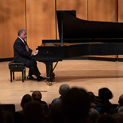 Jeffrey Siegel seated at a grand piano