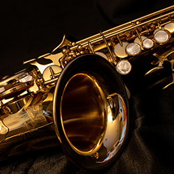 A saxophone in front of a dark background.