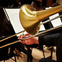 A trombonist plays onstage.