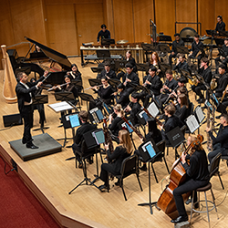 Roberty Taylor conducts the Symphonic Wind Ensemble onstage.