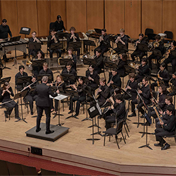 Shawn Vondran conducts the Symphonic Band onstage Pick-Staiger.