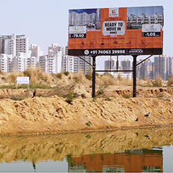 Still of a real estate sign from Not Just Roads documentary