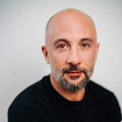 Headshot of Jules Rosskam in black shirt