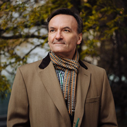 Stephen Hough poses outdoors.