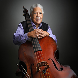 Rufus Reid sits with his upright bass.