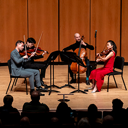 The Dover Quartet performs onstage.