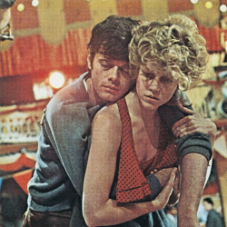 Exhausted, a woman drags a man over her shoulder around a ballroom