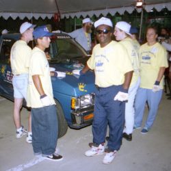 People wearing yellow shirts must keep one hand on a truck