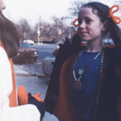 A young girl opens a fur coat