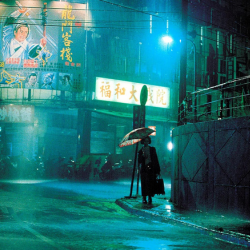 woman walks alone down rainy street