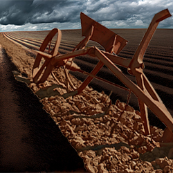 An old-fashioned plow in a furrow on a hill